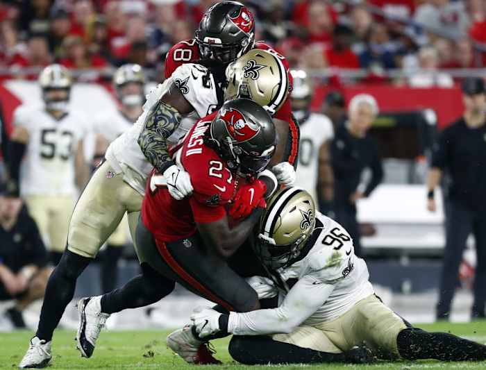 Dec 19, 2021; New Orleans Saints linebacker Demario Davis (56) and defensive end Carl Granderson (96) tackle Tampa Bay Buccaneers running back Ronald Jones (27). Mandatory Credit: Kim Klement-USA TODAY Sports